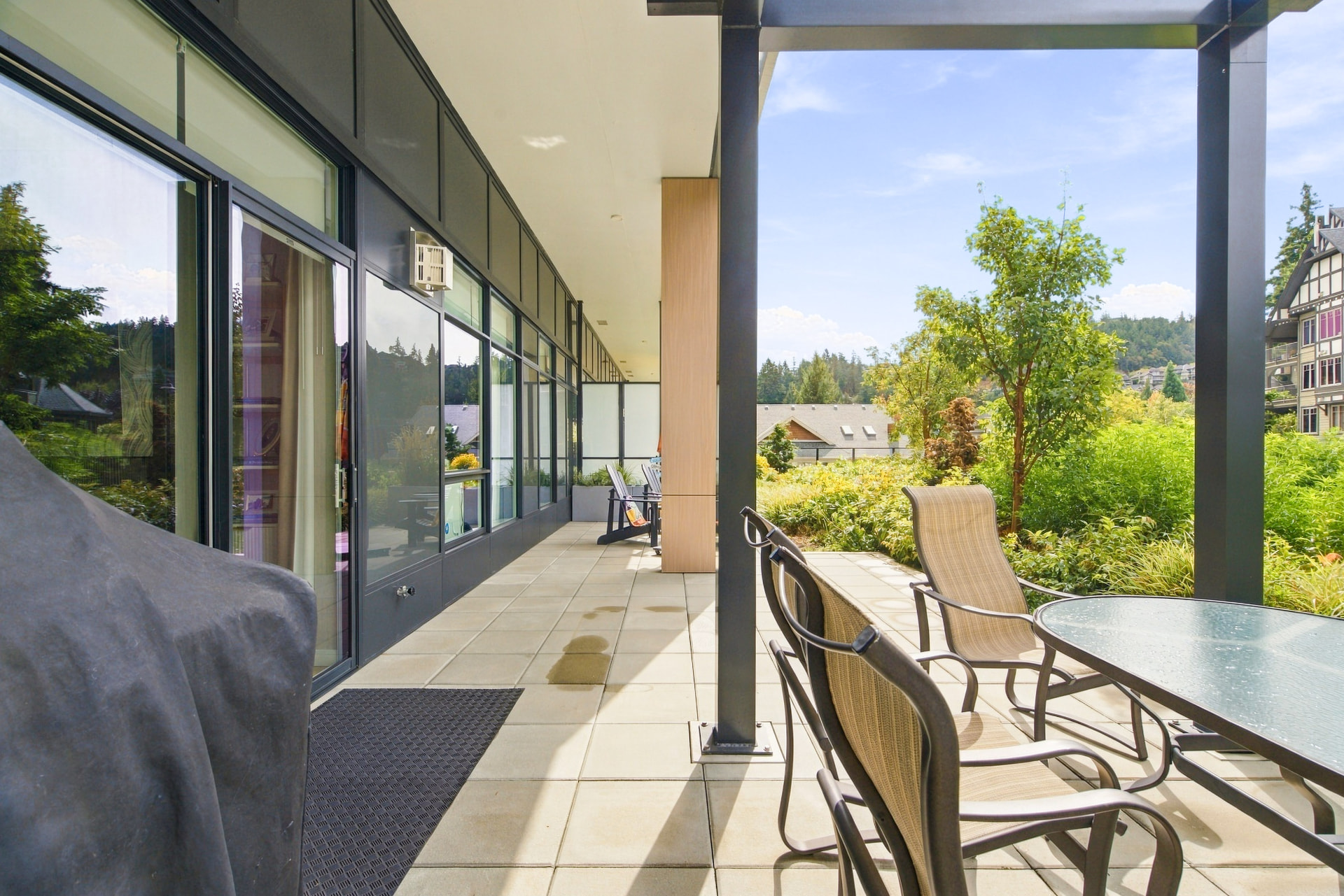 Covered Garden Terrace patio with outdoor dining furniture and landscaped grounds